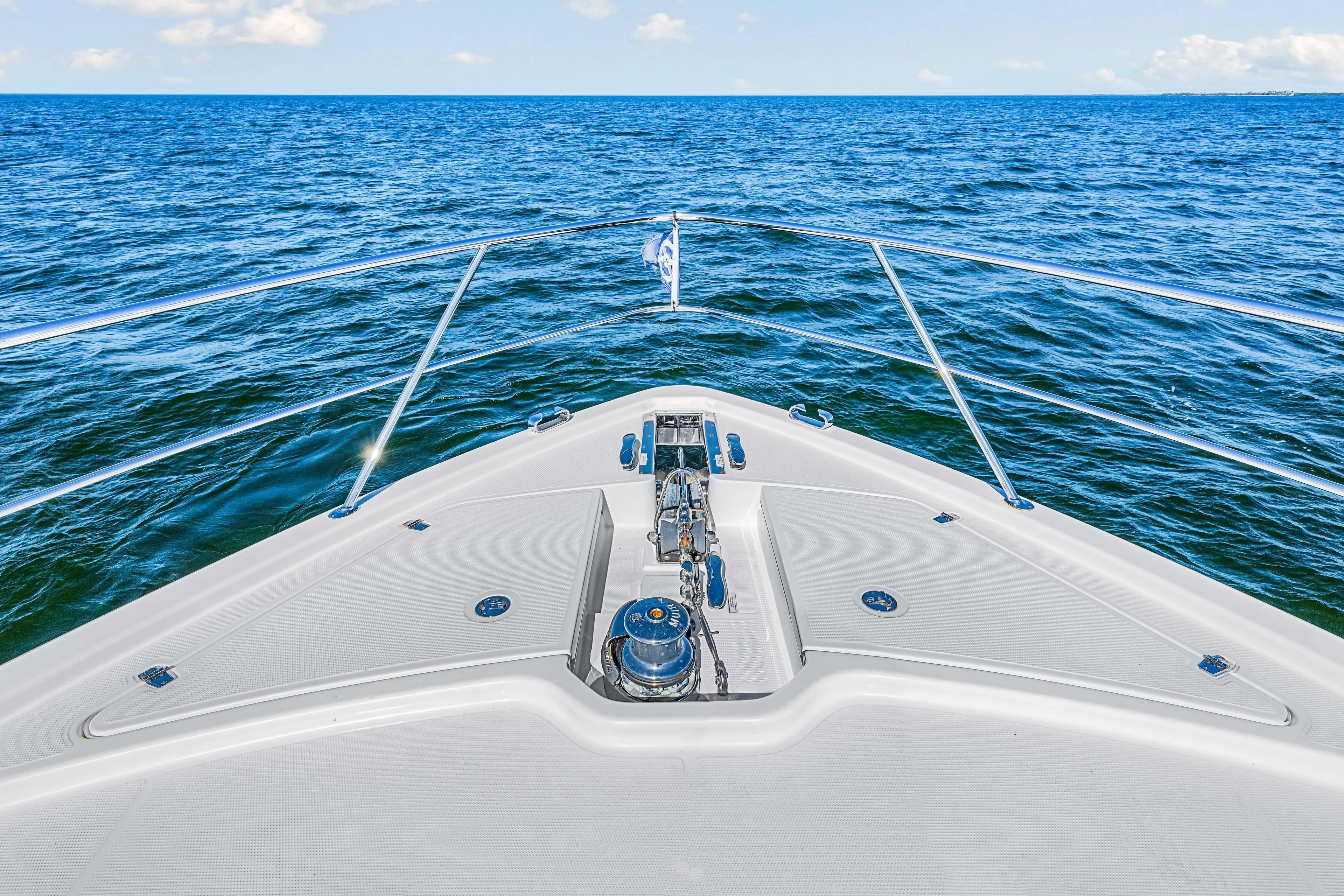  Yacht Photos Pics Bow view of 2022 Riviera 505 SUV yacht cruising on open sea.