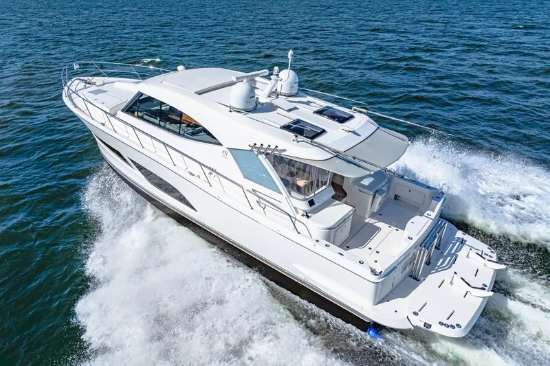  Yacht Photos Pics 2022 Riviera 505 SUV cruising on open water, showcasing sleek design and powerful performance.