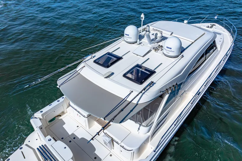  Yacht Photos Pics 2022 Riviera 505 SUV yacht cruising on open water, aerial view.