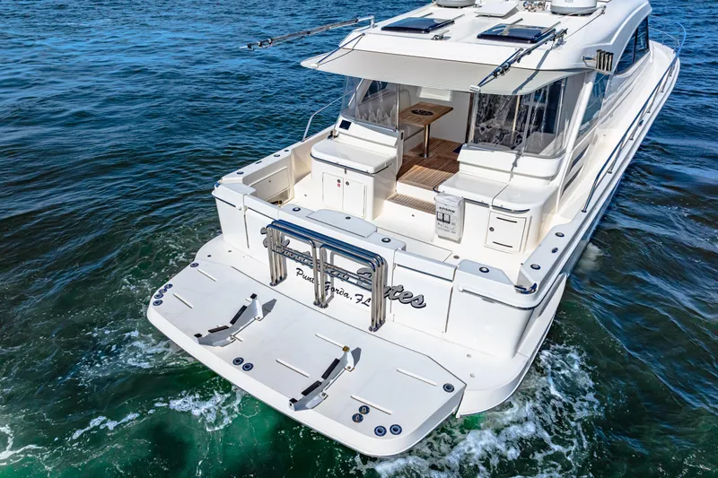  Yacht Photos Pics 2022 Riviera 505 SUV luxury yacht cruising on open water.