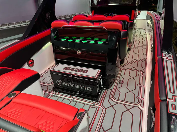  Yacht Photos Pics 2018 Mystic Powerboats M4200 interior with red and black seating, modern design, and illuminated controls.