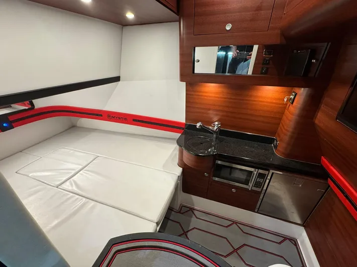  Yacht Photos Pics Luxurious interior of 2018 Mystic Powerboats M4200 with modern amenities and sleek design.