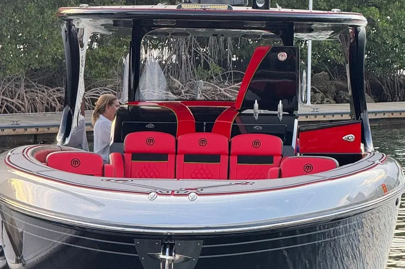  Yacht Photos Pics 2018 Mystic Powerboats M4200 with red seating, docked near mangroves.