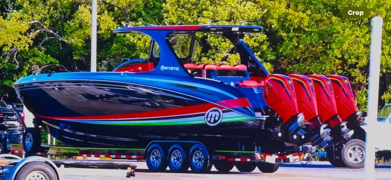  Yacht Photos Pics 2018 Mystic Powerboats M4200 with vibrant design and multiple engines on a trailer.