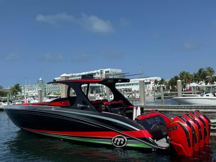  Yacht Photos Pics 2018 Mystic Powerboats M4200 docked, featuring sleek design and vibrant colors.