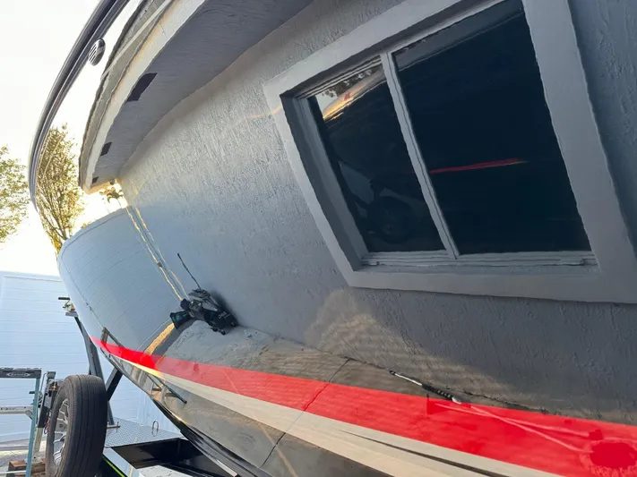  Yacht Photos Pics 2018 Mystic Powerboats M4200 with sleek design and vibrant red stripe detailing.