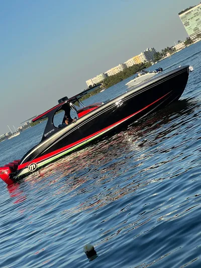  Yacht Photos Pics 2018 Mystic Powerboats M4200 on calm water, cityscape in background.