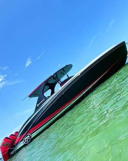  Yacht Photos Pics 2018 Mystic Powerboats M4200 on clear water under blue sky.