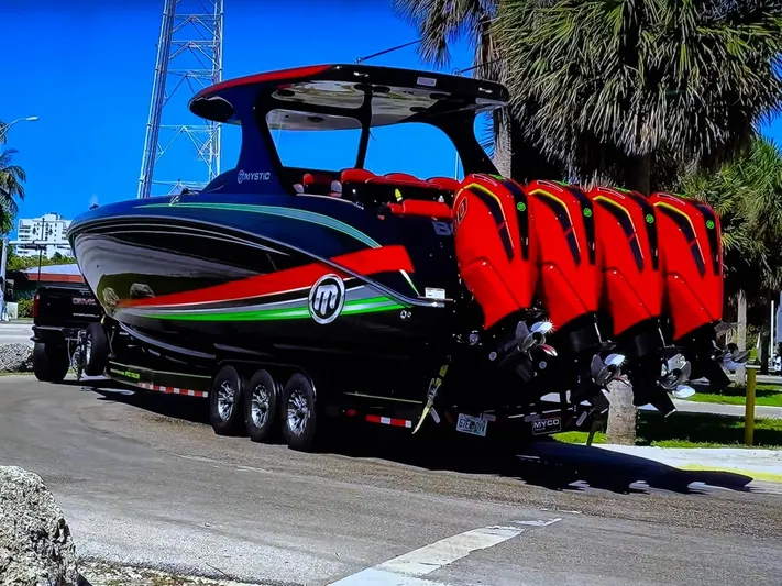  Yacht Photos Pics 2018 Mystic Powerboats M4200 with multiple engines on a trailer, parked near palm trees.