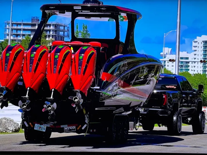  Yacht Photos Pics 2018 Mystic Powerboats M4200 with multiple engines on trailer, parked near modern buildings.