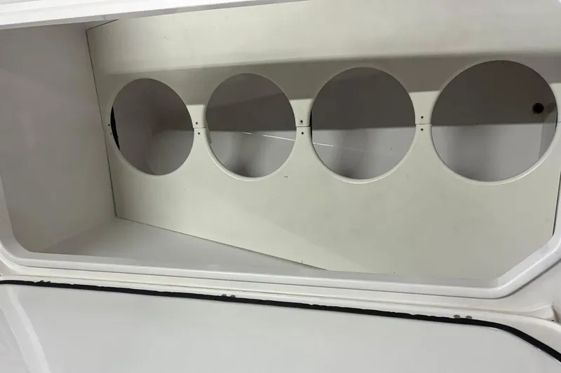  Yacht Photos Pics Storage compartment of a 2018 Mystic Powerboats M4200 with circular cutouts.