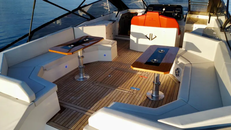 Ischia Yacht Photos Pics Luxurious 2024 BB Yachts 44 Ischia interior with elegant seating and wooden tables.