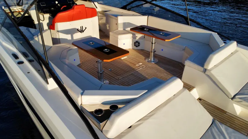 Ischia Yacht Photos Pics Luxurious 2024 BB Yachts 44 Ischia deck with seating and tables on the water.