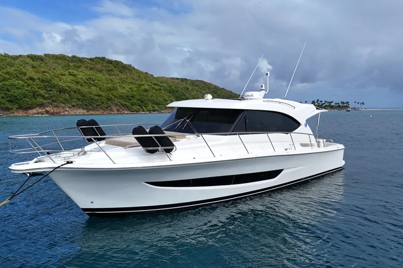  Yacht Photos Pics 2020 Riviera 395 SUV yacht anchored in scenic tropical waters.