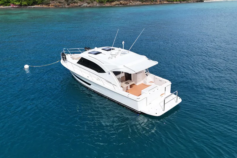  Yacht Photos Pics 2020 Riviera 395 SUV yacht anchored in clear blue water, viewed from above.