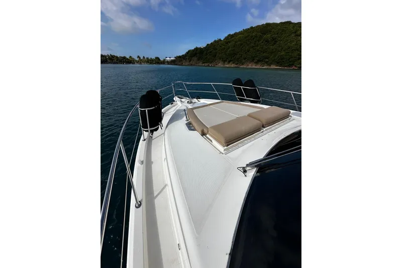  Yacht Photos Pics 2020 Riviera 395 SUV yacht with sunbathing deck on calm water.