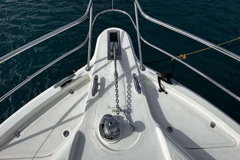  Yacht Photos Pics Bow view of 2020 Riviera 395 SUV yacht with anchor chain and railing.