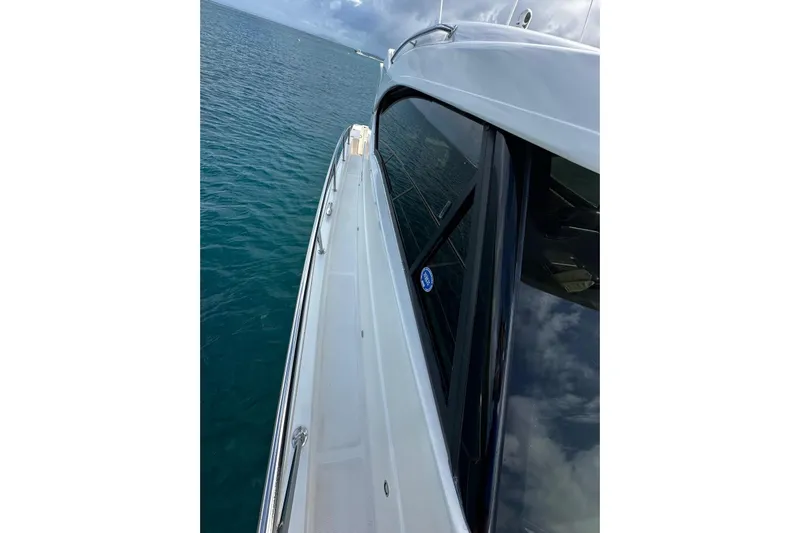  Yacht Photos Pics 2020 Riviera 395 SUV yacht cruising on calm blue waters.