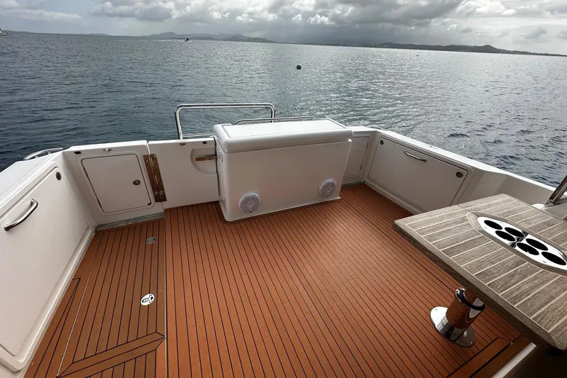  Yacht Photos Pics Riviera 395 SUV 2020 boat deck with wood finish, overlooking calm ocean waters.