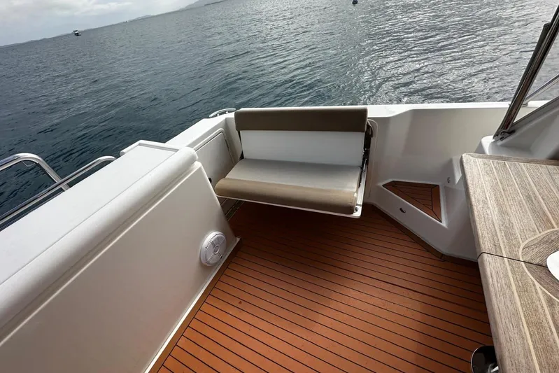  Yacht Photos Pics 2020 Riviera 395 SUV boat deck with seating, overlooking calm ocean waters.