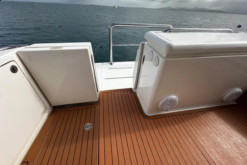  Yacht Photos Pics 2020 Riviera 395 SUV boat deck with teak flooring, overlooking calm ocean waters.