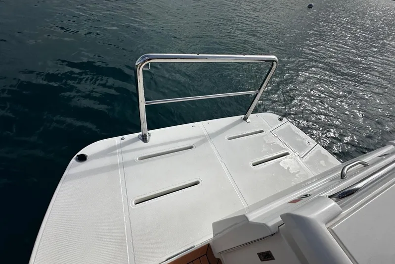  Yacht Photos Pics 2020 Riviera 395 SUV swim platform with railing on calm water.