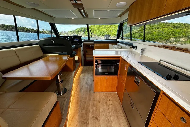  Yacht Photos Pics Interior of 2020 Riviera 395 SUV yacht with modern kitchen and dining area.