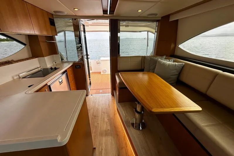  Yacht Photos Pics Interior of 2020 Riviera 395 SUV yacht with modern kitchen and cozy seating area.