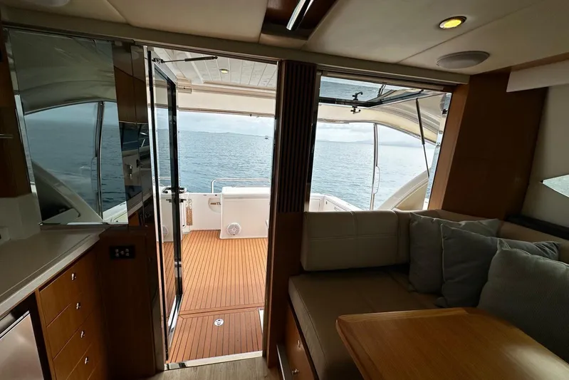  Yacht Photos Pics Interior view of 2020 Riviera 395 SUV yacht, featuring elegant wood finishes and ocean view.