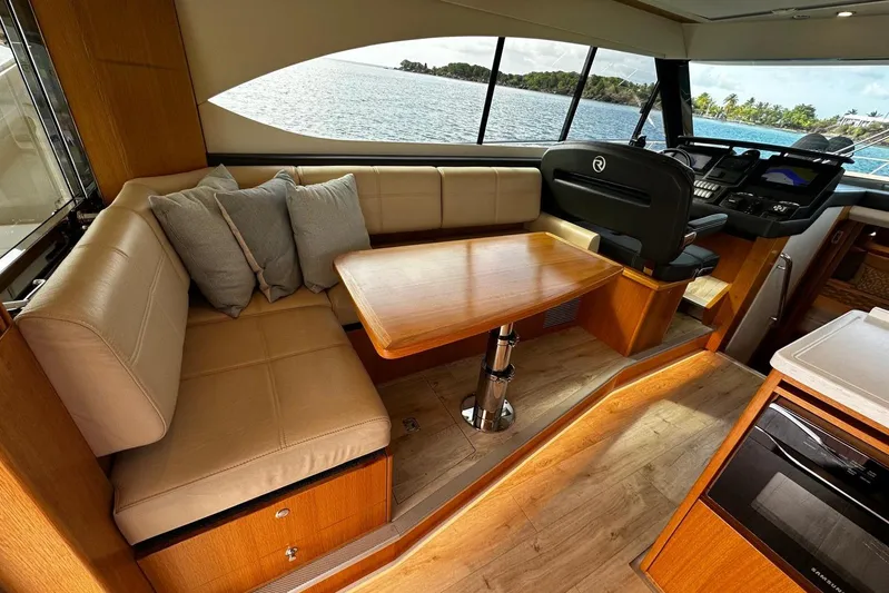 Yacht Photos Pics Luxurious interior of 2020 Riviera 395 SUV yacht with seating and helm.