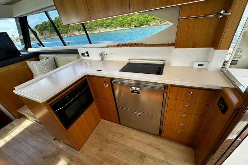  Yacht Photos Pics Modern kitchen interior of 2020 Riviera 395 SUV yacht with ocean view.