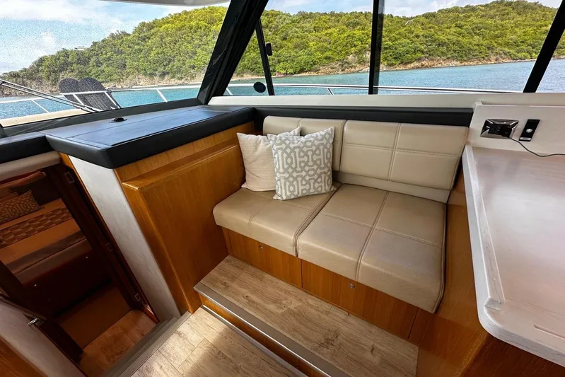  Yacht Photos Pics Interior of 2020 Riviera 395 SUV yacht with beige seating and scenic ocean view.