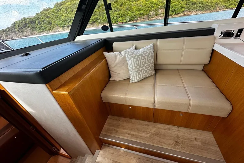 Yacht Photos Pics Luxurious interior seating of 2020 Riviera 395 SUV yacht with scenic ocean view.