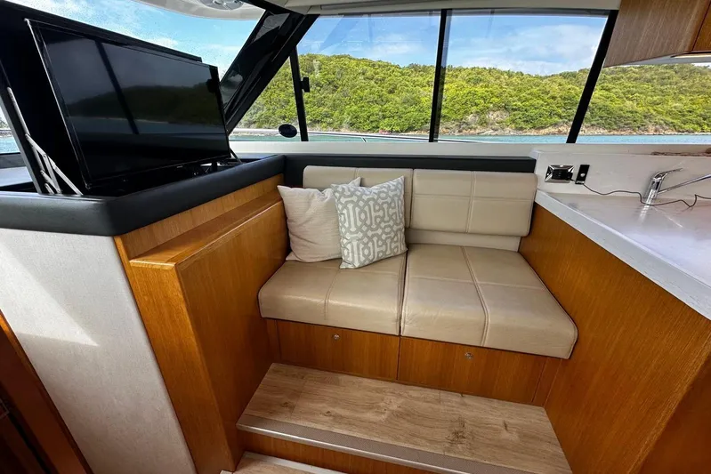  Yacht Photos Pics Luxurious interior of 2020 Riviera 395 SUV with leather seating and scenic window view.
