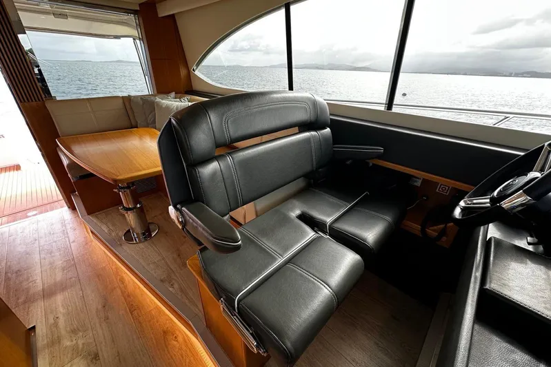  Yacht Photos Pics Interior of 2020 Riviera 395 SUV yacht with leather seating and wooden table.