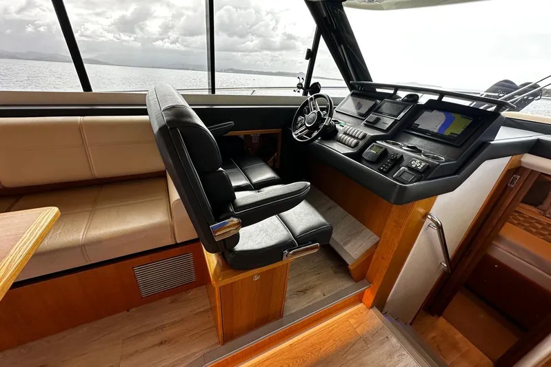  Yacht Photos Pics Interior of 2020 Riviera 395 SUV boat with modern helm and seating.