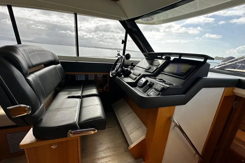  Yacht Photos Pics Interior of 2020 Riviera 395 SUV yacht with modern helm and leather seating.