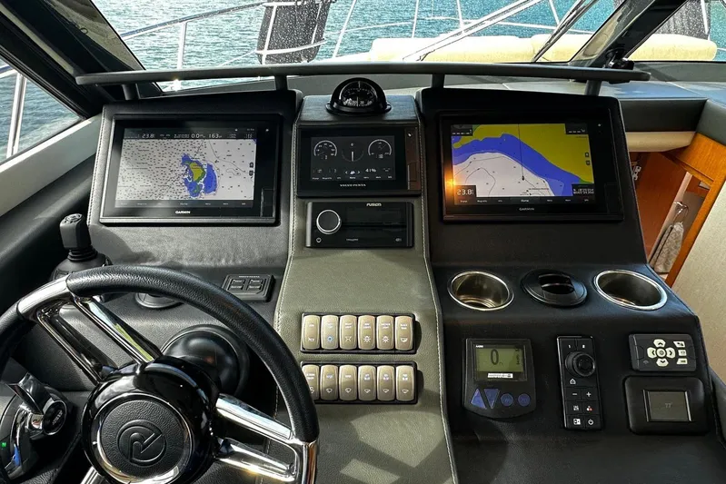  Yacht Photos Pics Cockpit of 2020 Riviera 395 SUV with navigation screens and controls.