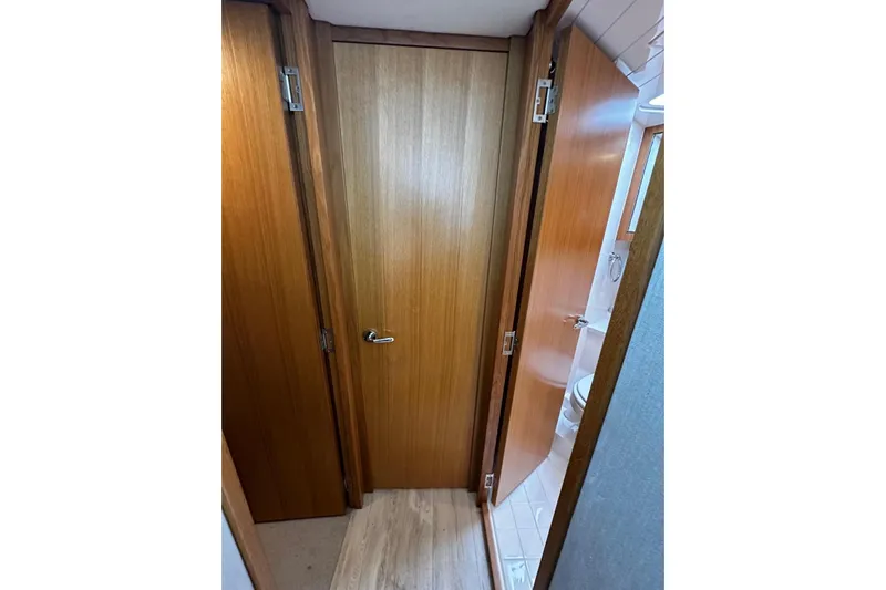  Yacht Photos Pics Interior view of 2020 Riviera 395 SUV, featuring wooden doors and bathroom access.