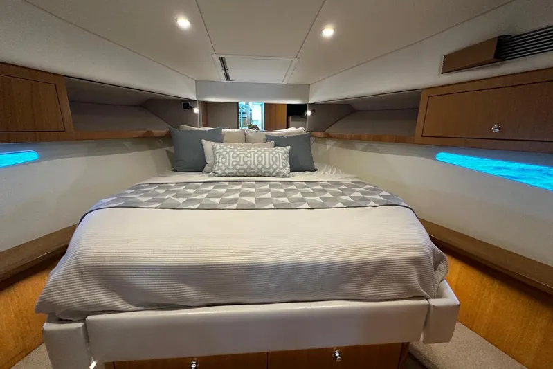  Yacht Photos Pics Luxurious interior cabin of 2020 Riviera 395 SUV yacht with cozy bedding.