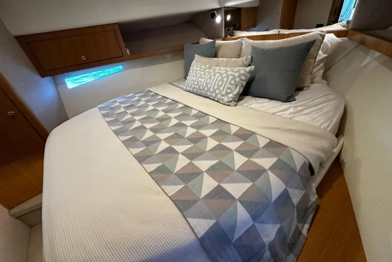  Yacht Photos Pics Luxurious bedroom interior of 2020 Riviera 395 SUV yacht with geometric bedding.