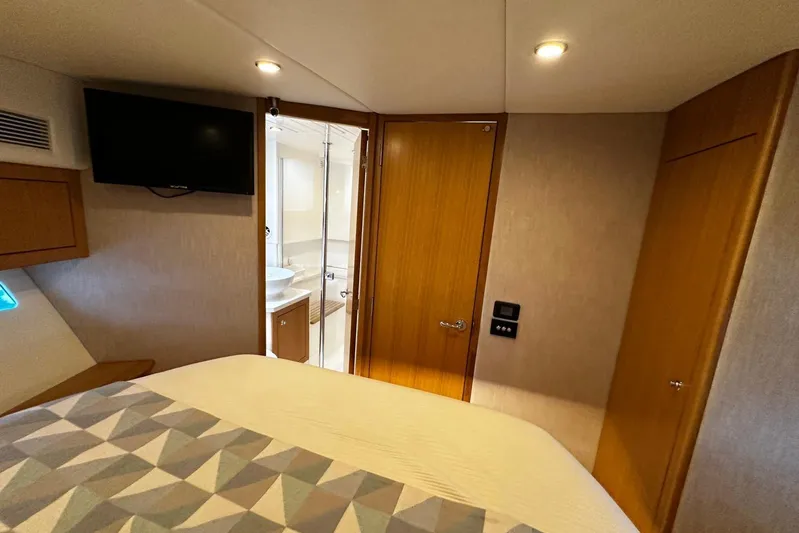  Yacht Photos Pics 2020 Riviera 395 SUV interior cabin with bed, TV, and bathroom view.