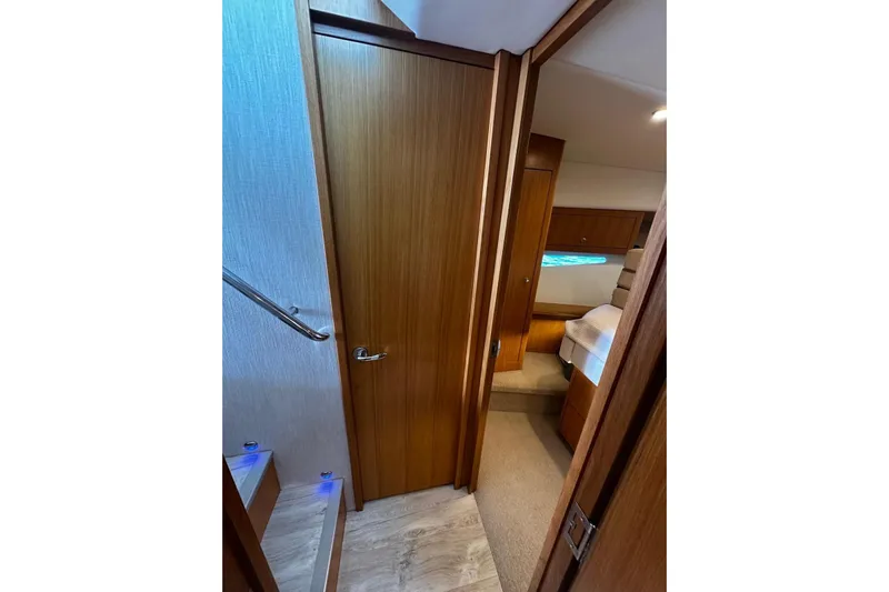  Yacht Photos Pics Interior view of 2020 Riviera 395 SUV, featuring wooden doors and cozy cabin space.