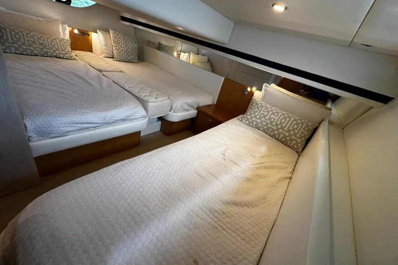  Yacht Photos Pics Luxurious interior cabin of 2020 Riviera 395 SUV with twin beds and elegant decor.