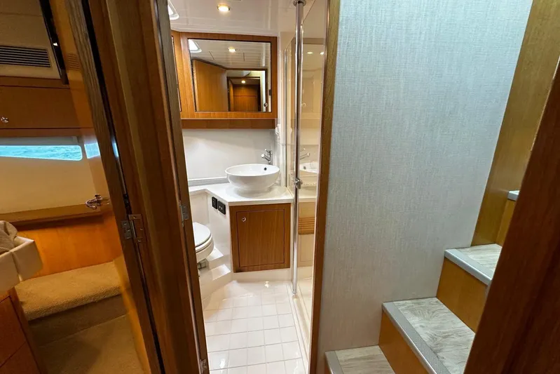  Yacht Photos Pics Interior of 2020 Riviera 395 SUV yacht, featuring a modern bathroom and cozy cabin.