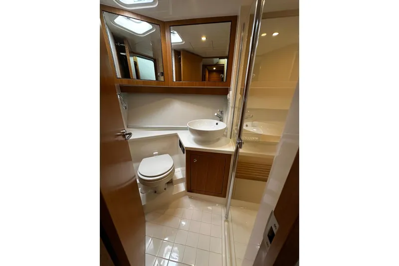  Yacht Photos Pics Luxurious bathroom in 2020 Riviera 395 SUV yacht with modern fixtures and elegant design.