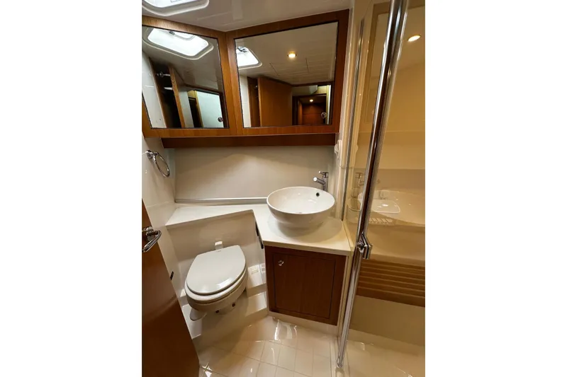  Yacht Photos Pics Luxurious bathroom in 2020 Riviera 395 SUV yacht with modern fixtures and elegant design.