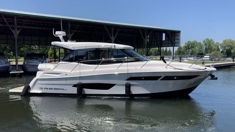  Yacht Photos Pics 2021 Regal 38 Grande Coupe yacht docked in marina, side view.