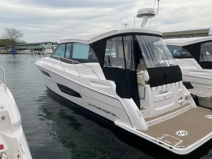  Yacht Photos Pics 2021 Regal 38 Grande Coupe yacht docked at a marina.