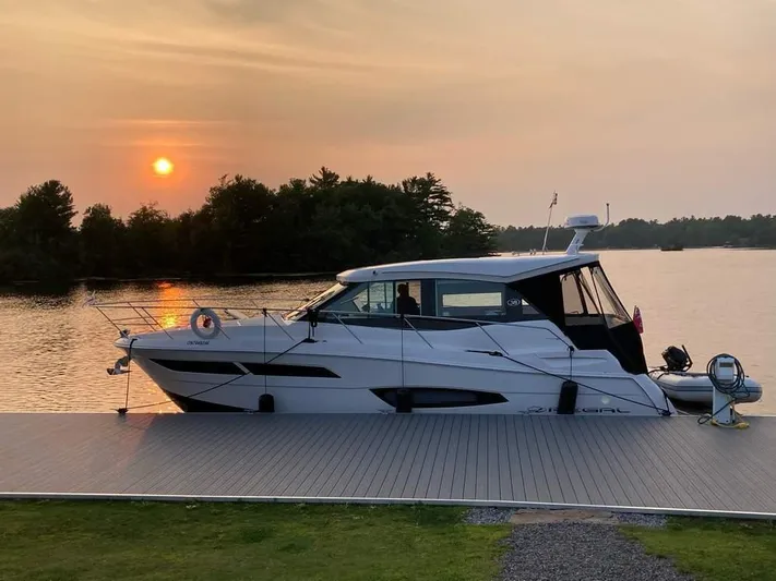  Yacht Photos Pics 2021 Regal 38 Grande Coupe docked at sunset by a serene lake.